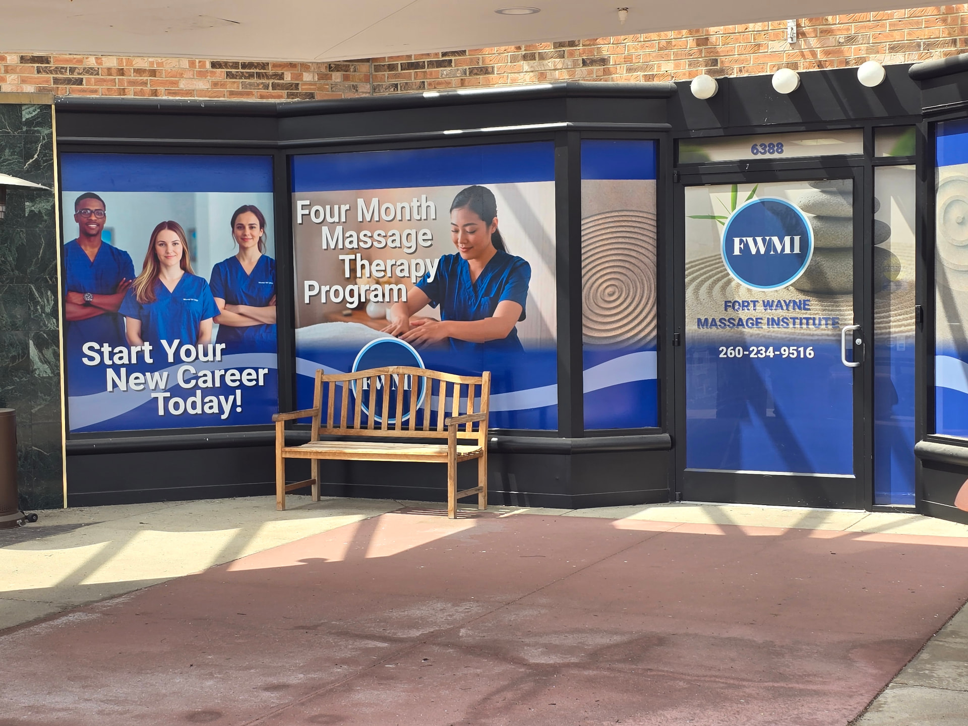 Perforated window decals wrapping a massage institute storefront